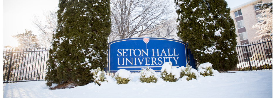 Seton Hall University sign covered in snow.