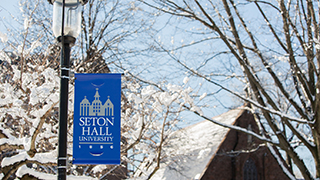Seton Hall pole banner on the campus during winter
