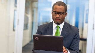 A faculty member working on a laptop.  