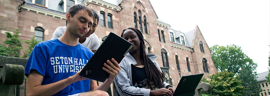 DoIt Students on tablet on the University Green.