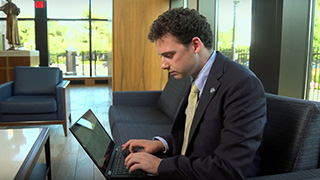 Diplomacy student Matthew Minor working on his laptop.