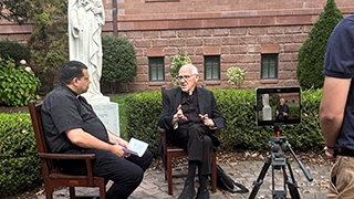 Msgr. Liddy being interviewed.