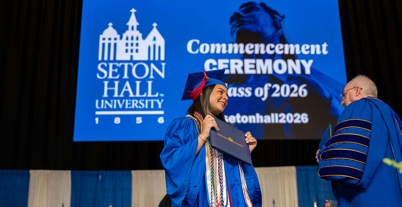Baccalaureate Commencement 2026 A photo of a student getting their diploma at graduation.