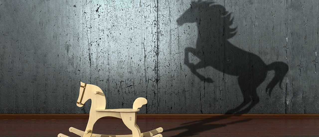 A photo of a rocking horse with a stallion shadow representing hidden potential.