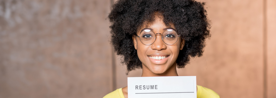Student holding up a resume.