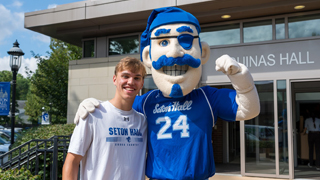 Image of a student and the pirate during move in day. 