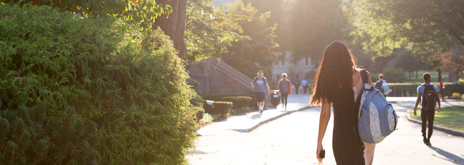 student walking into the sunset